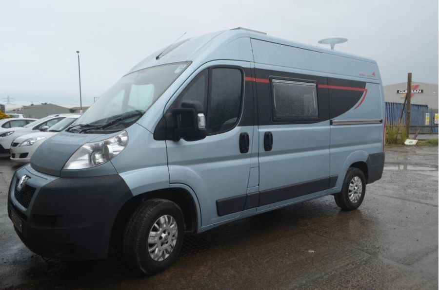 silver campervan parked in a lot
