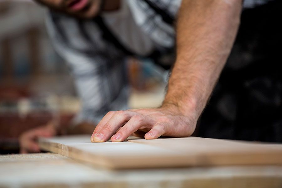 man cutting wood