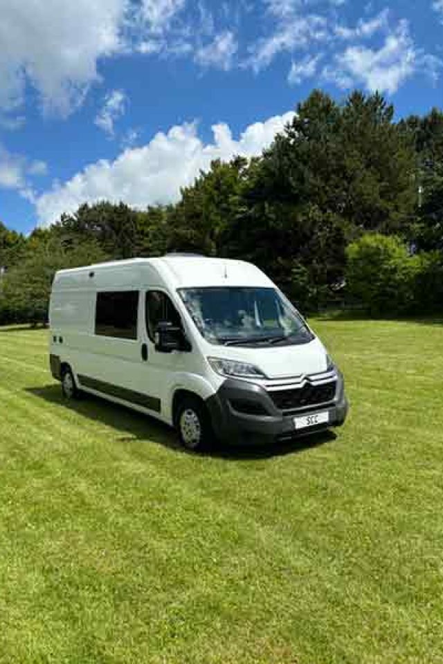 Family driving off in a new custom campervan - SCC Conversions